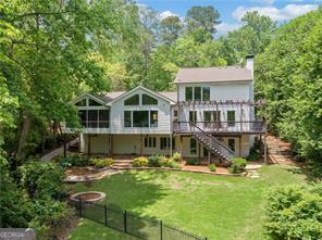 8190 Old Mill Dr, Gainesville, GA 30506 - rear view of property featuring stairs, a wooden deck, and a chimney