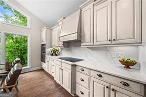 8190 Old Mill Dr, Gainesville, GA 30506 - kitchen with black electric cooktop, custom range hood, light countertops, double oven, and dark wood finished floors
