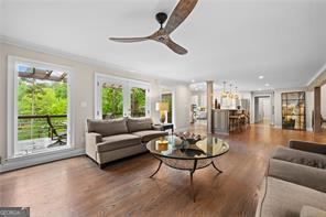 8190 Old Mill Dr, Gainesville, GA 30506 - living area with wood finished floors, a ceiling fan, and crown molding