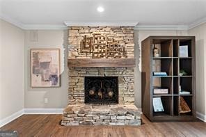 8190 Old Mill Dr, Gainesville, GA 30506 - unfurnished living room with ornamental molding, a stone fireplace, wood finished floors, and baseboards