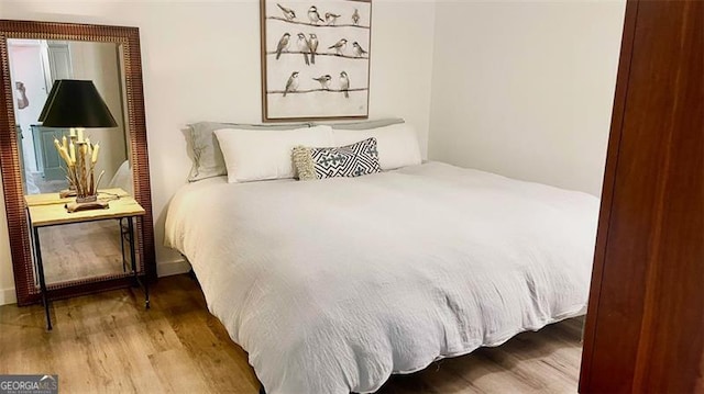 bedroom with wood finished floors
