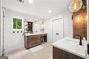 8190 Old Mill Dr, Gainesville, GA 30506 - full bathroom with two vanities, crown molding, tile patterned flooring, and baseboards