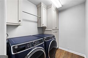 8190 Old Mill Dr, Gainesville, GA 30506 - laundry area with washing machine and dryer, cabinet space, dark wood finished floors, and baseboards