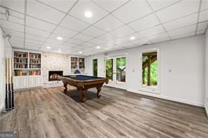 8190 Old Mill Dr, Gainesville, GA 30506 - playroom featuring a fireplace, built in shelves, baseboards, billiards, and a drop ceiling