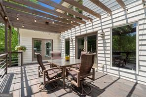 8190 Old Mill Dr, Gainesville, GA 30506 - wooden deck featuring a pergola and outdoor dining space