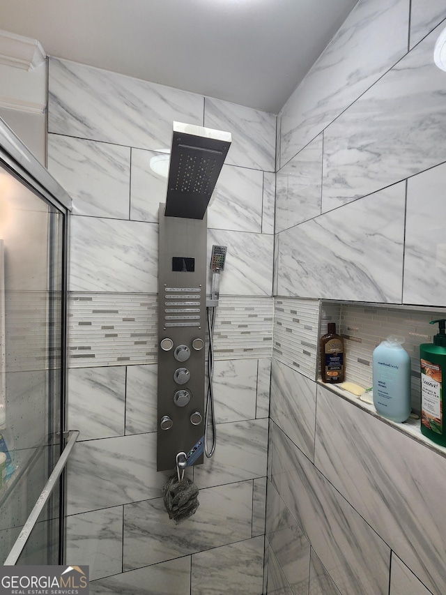 bathroom with tiled shower