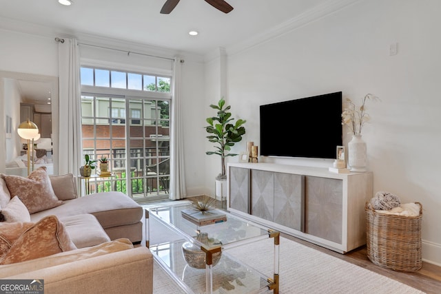 living area with baseboards, a ceiling fan, crown molding, wood finished floors, and recessed lighting