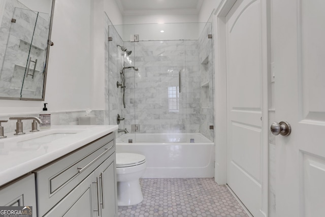 bathroom featuring crown molding, toilet, vanity, and tub / shower combination