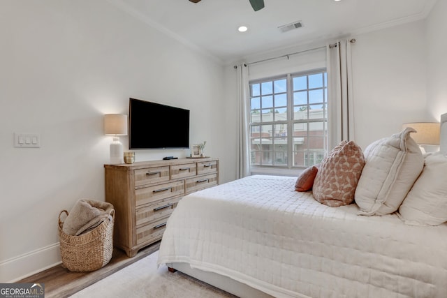 bedroom featuring crown molding, baseboards, recessed lighting, a ceiling fan, and light wood-style floors