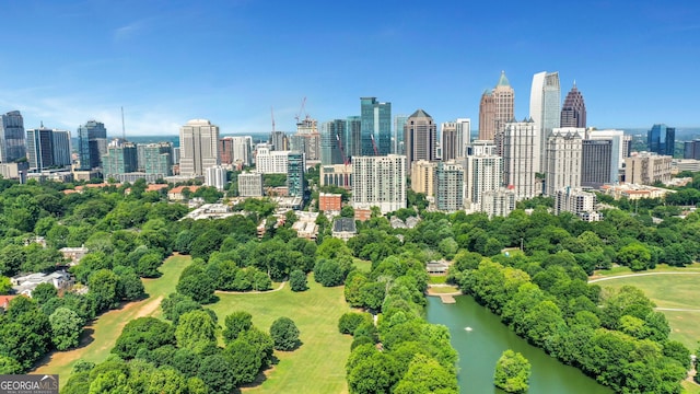 city view with a tree filled landscape and a nearby body of water