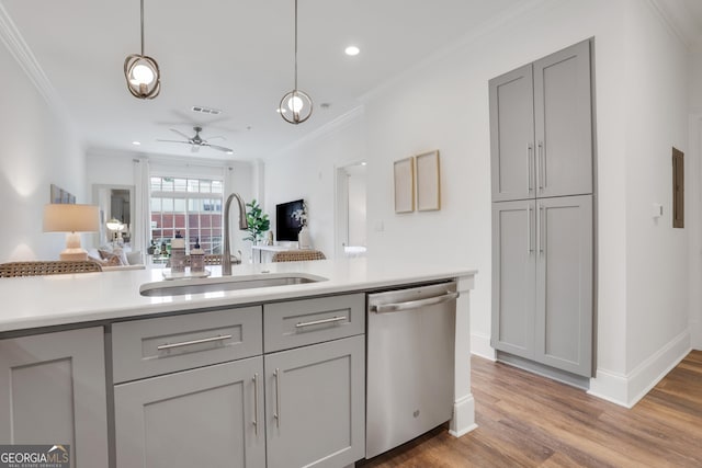 kitchen featuring gray cabinetry, dishwasher, a sink, ceiling fan, and light countertops