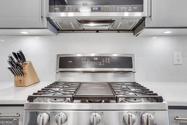 kitchen featuring range with gas cooktop and light countertops