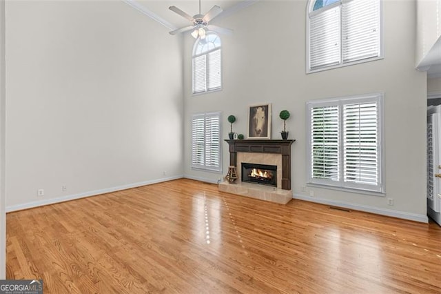 4876 Sara Creek Way, Sugar Hill, GA 30518 - unfurnished living room with crown molding, a high end fireplace, a high ceiling, and wood finished floors