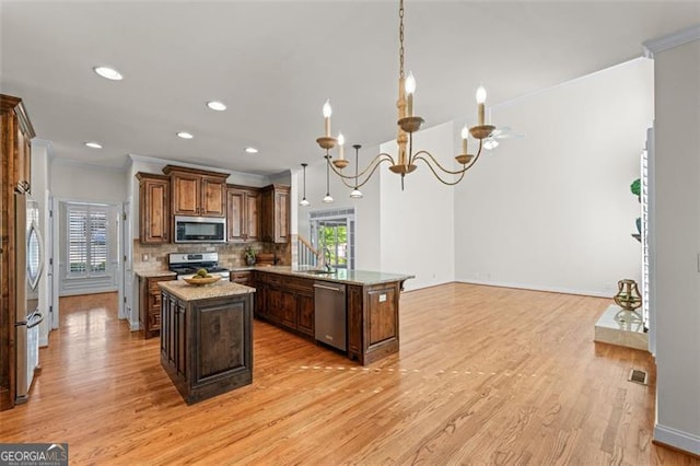 4876 Sara Creek Way, Sugar Hill, GA 30518 - kitchen with ornamental molding, a peninsula, a wealth of natural light, and stainless steel appliances