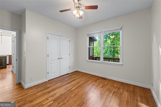 4876 Sara Creek Way, Sugar Hill, GA 30518 - unfurnished bedroom featuring visible vents, a closet, baseboards, a ceiling fan, and light wood finished floors