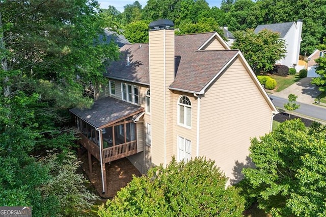 4876 Sara Creek Way, Sugar Hill, GA 30518 - back of property with a sunroom, roof with shingles, and a chimney