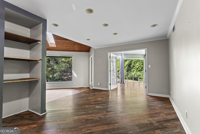 unfurnished living room featuring dark wood-style flooring, baseboards, and ornamental molding