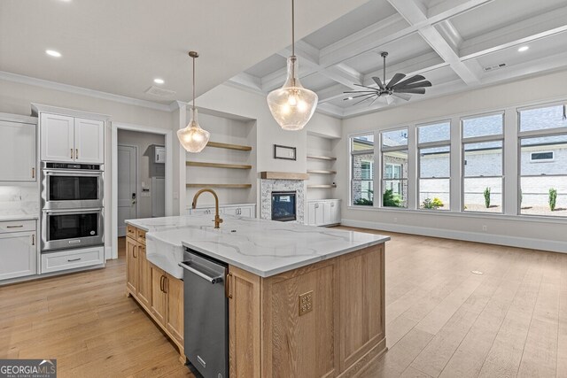 2824 Cork St, Braselton, GA 30517 - kitchen with a sink, appliances with stainless steel finishes, light wood-type flooring, an island with sink, and a ceiling fan