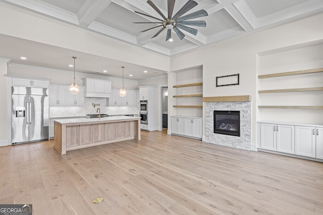 2824 Cork St, Braselton, GA 30517 - kitchen featuring appliances with stainless steel finishes, ceiling fan, open floor plan, light countertops, and a kitchen island with sink