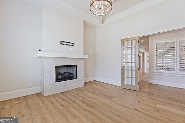 2824 Cork St, Braselton, GA 30517 - unfurnished living room with wood finished floors, a chandelier, a fireplace, baseboards, and a high ceiling