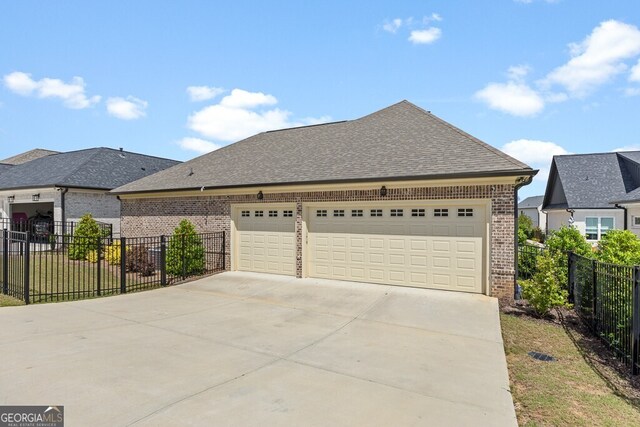 2824 Cork St, Braselton, GA 30517 - view of front facade with brick siding, driveway, roof with shingles, and an attached garage