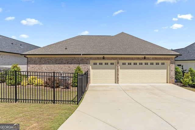 2824 Cork St, Braselton, GA 30517 - view of front of house featuring brick siding, driveway, roof with shingles, and a garage