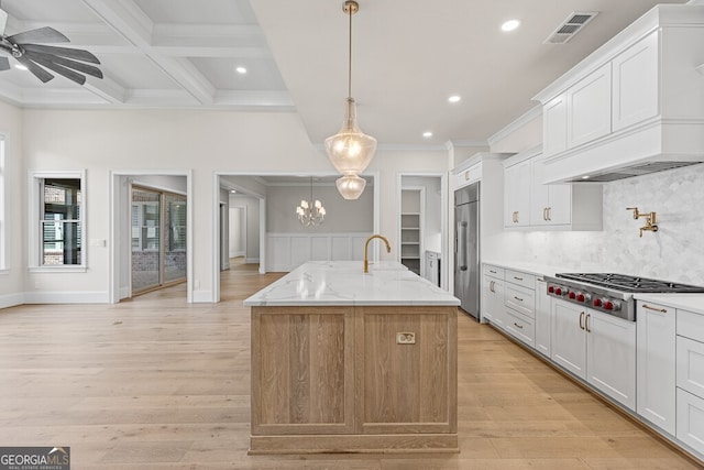 2824 Cork St, Braselton, GA 30517 - kitchen with stainless steel appliances, recessed lighting, crown molding, a kitchen island with sink, and light stone countertops