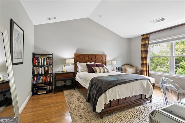 1365 Memorial Dr SE Unit # 12, Atlanta, GA 30317 - bedroom with lofted ceiling, wood finished floors, and baseboards