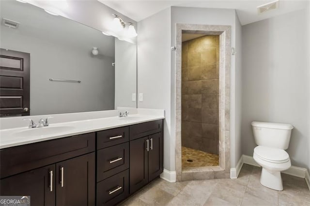 1365 Memorial Dr SE Unit # 12, Atlanta, GA 30317 - full bath with baseboards, toilet, tiled shower, double vanity, and tile patterned floors
