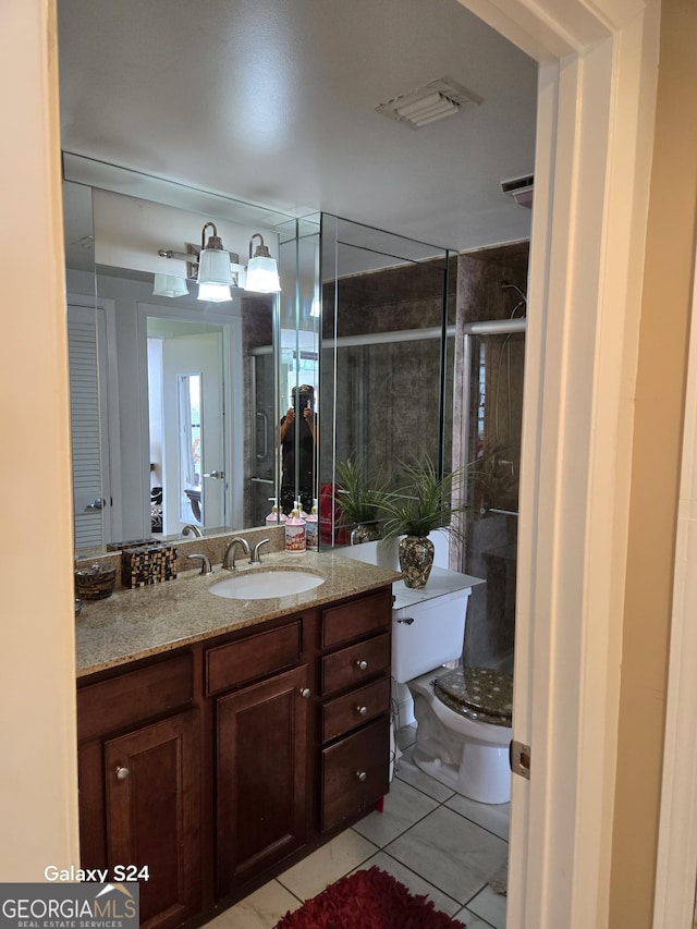 1280 W Peachtree St NW Apt 2606, Atlanta, GA 30309 - full bathroom with visible vents, vanity, toilet, tile patterned floors, and a shower stall