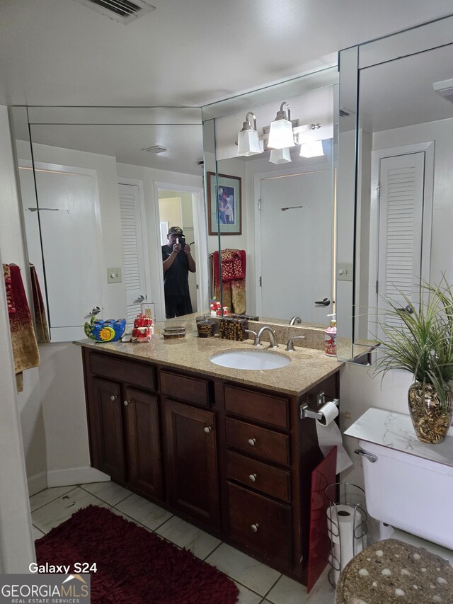 1280 W Peachtree St NW Apt 2606, Atlanta, GA 30309 - bathroom featuring vanity, tile patterned flooring, a closet, and visible vents