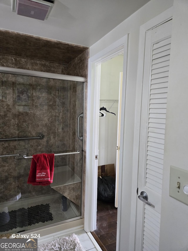 1280 W Peachtree St NW Apt 2606, Atlanta, GA 30309 - bathroom with a closet and a stall shower