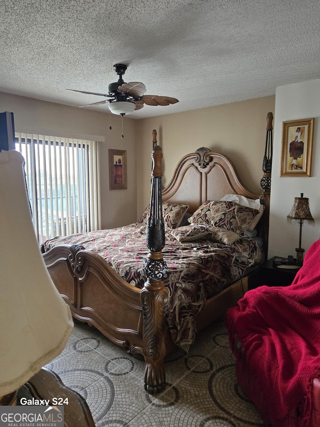 1280 W Peachtree St NW Apt 2606, Atlanta, GA 30309 - bedroom featuring a textured ceiling and ceiling fan