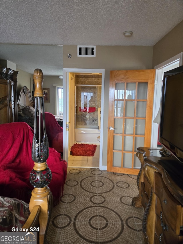 1280 W Peachtree St NW Apt 2606, Atlanta, GA 30309 - living room featuring tile patterned flooring, a textured ceiling, and visible vents