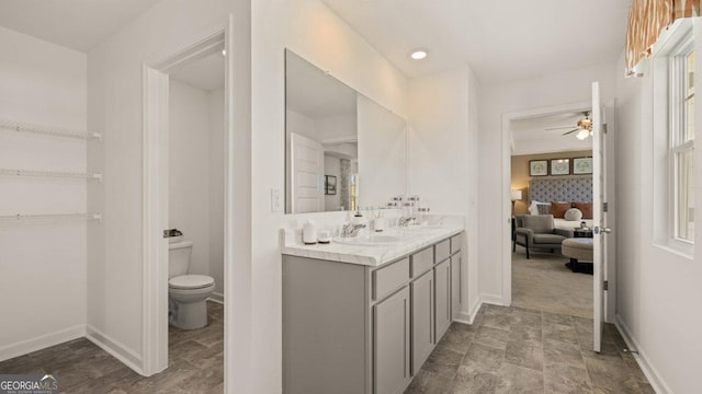 252 Kennelsman Dr, Griffin, GA 30224 - bathroom featuring baseboards, a ceiling fan, toilet, and ensuite bathroom