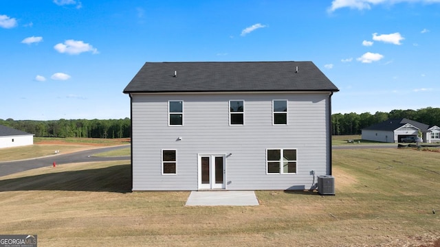 252 Kennelsman Dr, Griffin, GA 30224 - back of property featuring a lawn, cooling unit, and a patio