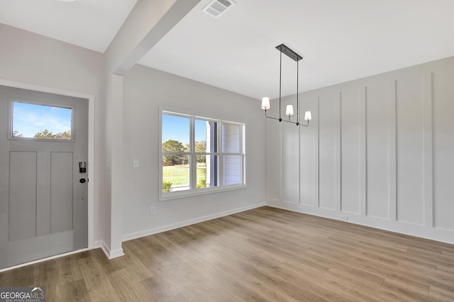 1100 Patterson Rd, Griffin, GA 30223 - foyer with visible vents, light wood-style flooring, a notable chandelier, and a healthy amount of sunlight