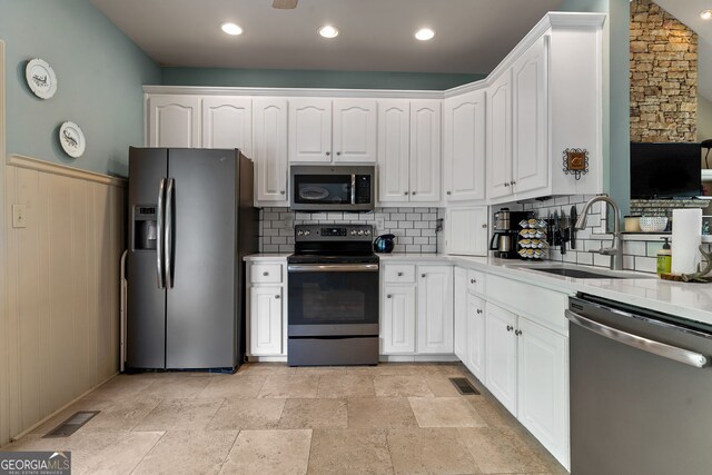 945 Sandy Run Dr, Sparta, GA 31087 - kitchen featuring backsplash, stainless steel appliances, white cabinets, and a sink