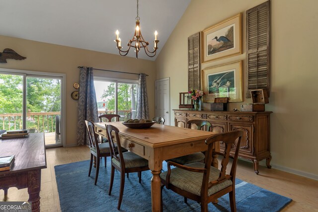 945 Sandy Run Dr, Sparta, GA 31087 - dining space featuring high vaulted ceiling, baseboards, light wood-type flooring, and a notable chandelier
