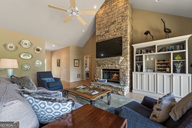 945 Sandy Run Dr, Sparta, GA 31087 - living area with a fireplace, high vaulted ceiling, a ceiling fan, wood finished floors, and visible vents