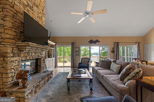 945 Sandy Run Dr, Sparta, GA 31087 - living area with a healthy amount of sunlight, high vaulted ceiling, ceiling fan, and a stone fireplace