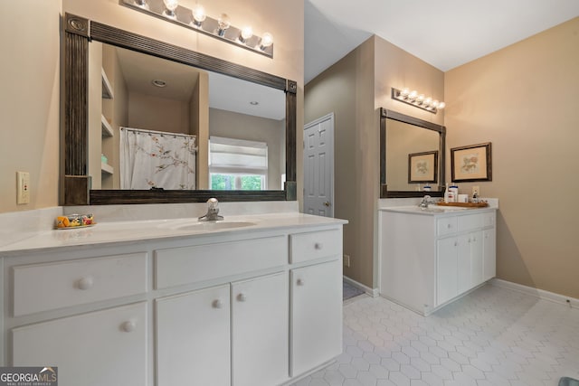 945 Sandy Run Dr, Sparta, GA 31087 - full bath with baseboards, a sink, two vanities, and tile patterned flooring