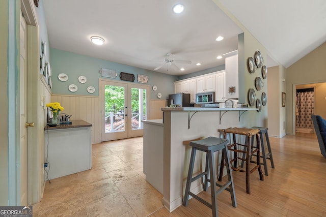 945 Sandy Run Dr, Sparta, GA 31087 - kitchen with a kitchen breakfast bar, a ceiling fan, french doors, appliances with stainless steel finishes, and a peninsula