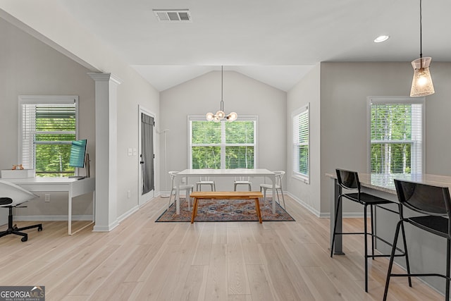dining area featuring light wood-style floors, visible vents, vaulted ceiling, and a wealth of natural light