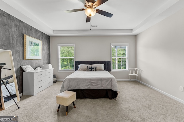 bedroom with baseboards, visible vents, multiple windows, and light carpet