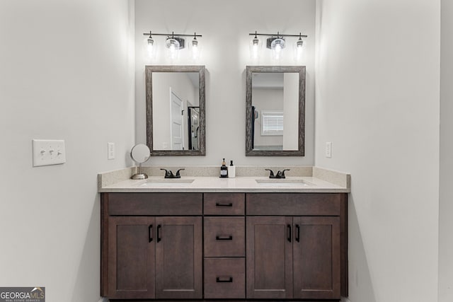 bathroom with a sink and double vanity