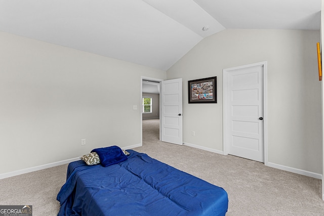 bedroom featuring vaulted ceiling, baseboards, and carpet flooring