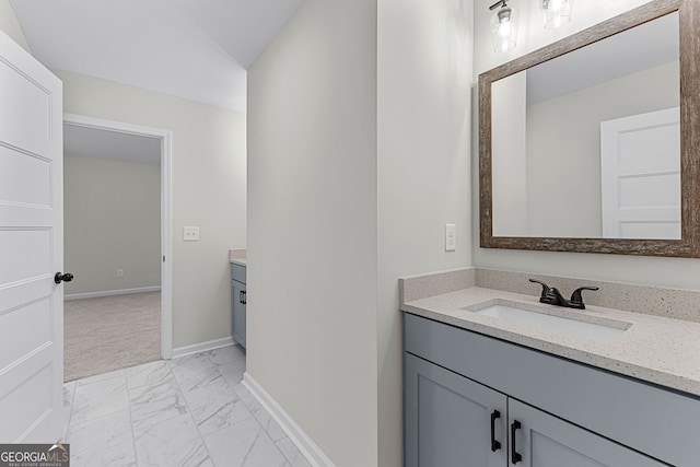 bathroom featuring vanity, baseboards, and marble finish floor