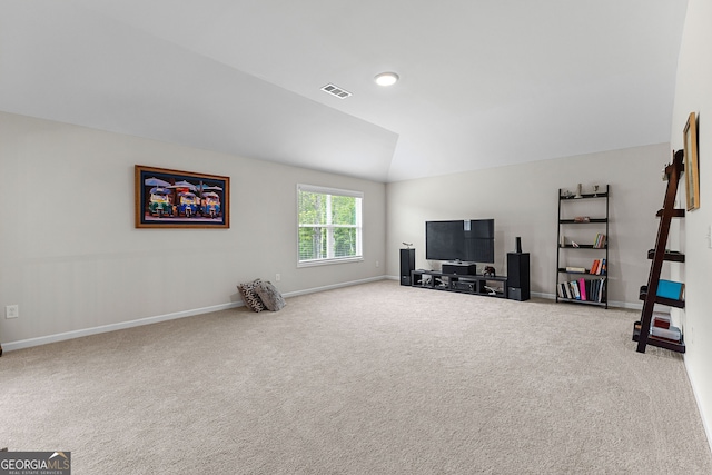 interior space featuring visible vents, carpet flooring, baseboards, and lofted ceiling