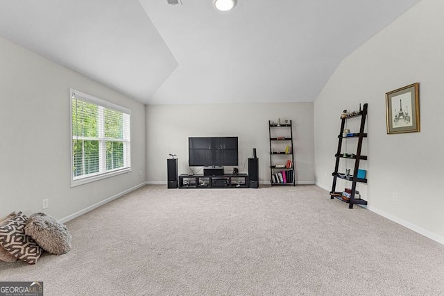 interior space with carpet floors, baseboards, and lofted ceiling